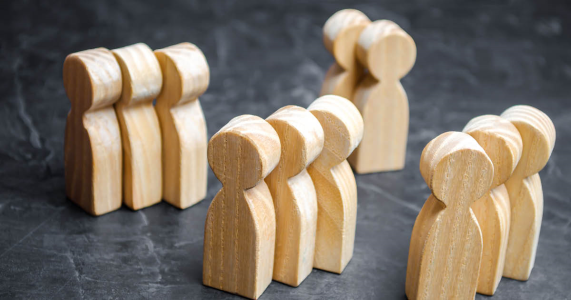 wooden people arranged in groups symbolizing customer segmentation